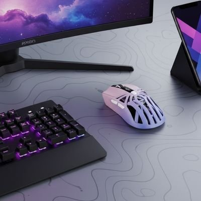 Souris Bluetooth ergonomique blanche avec design ajouré, posée sur bureau gris à côté d’un clavier noir rétroéclairé violet.  Clic ton jeu.